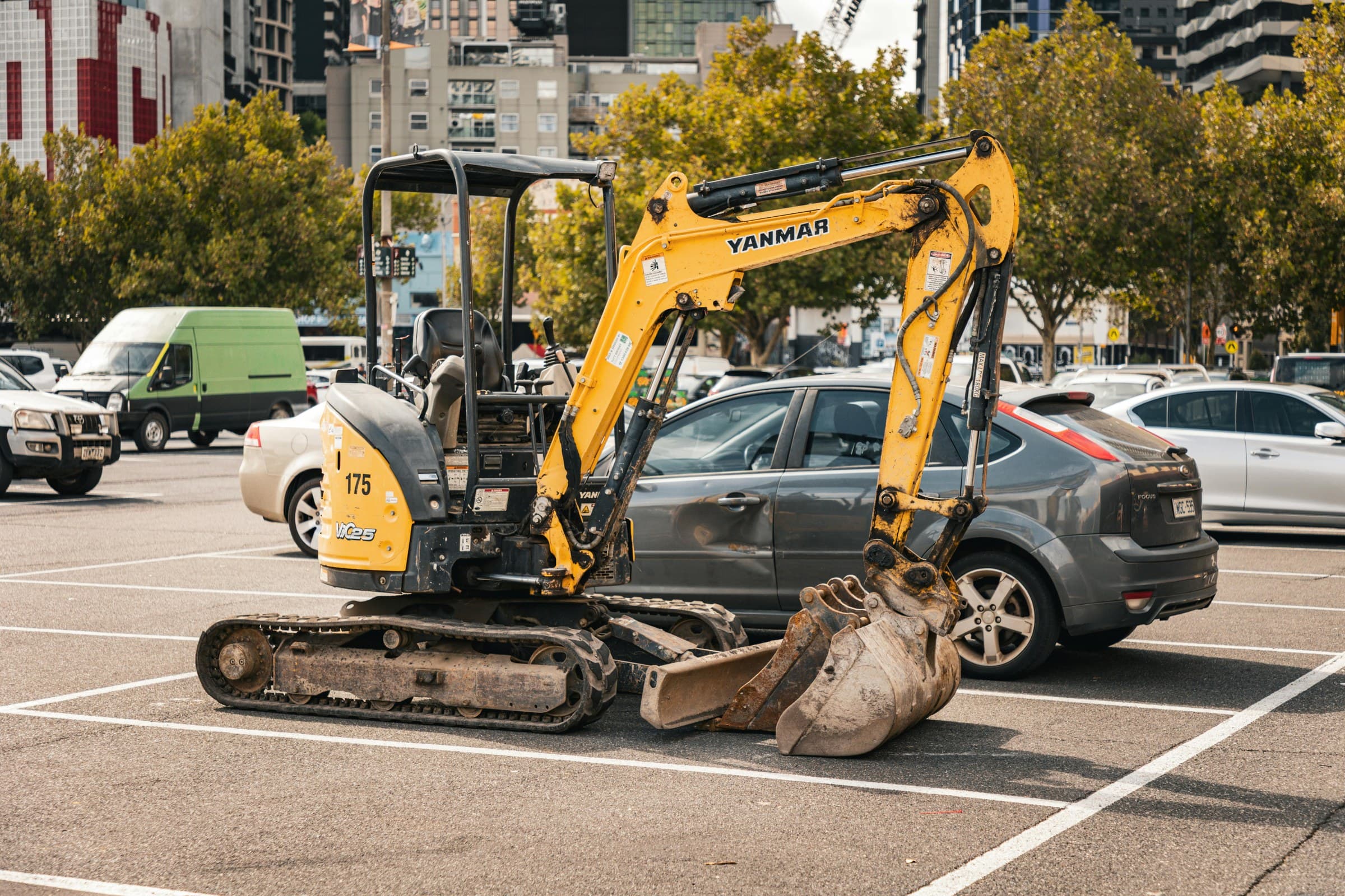 Yanmar mini excavator parked in an urban location